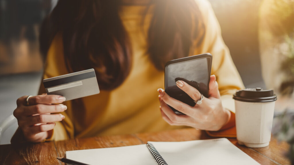 women holding credit card and her phone